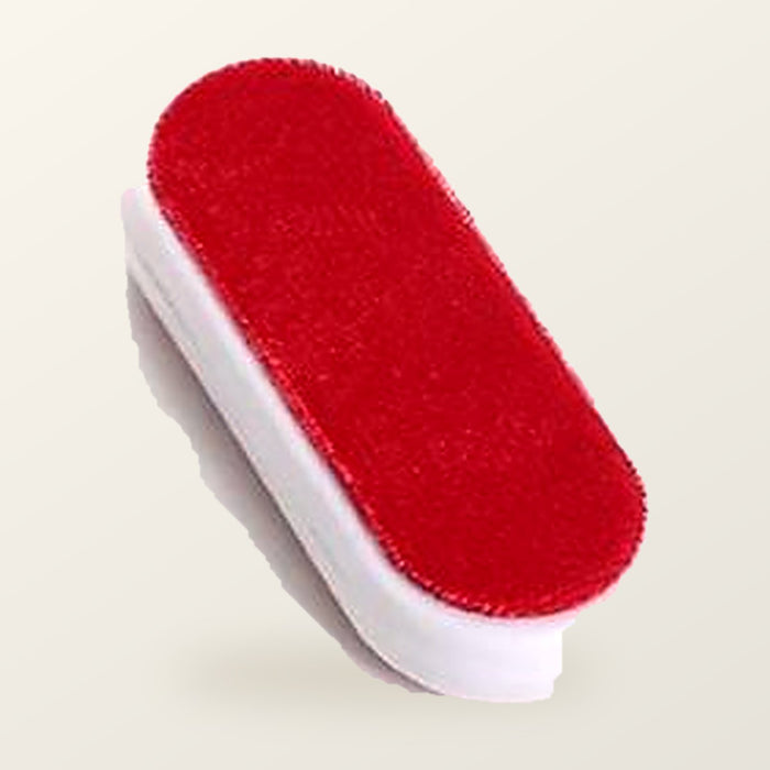 Double-sided self-cleaning lint brush with a red velvet pad and a white handle, on a warm cream background