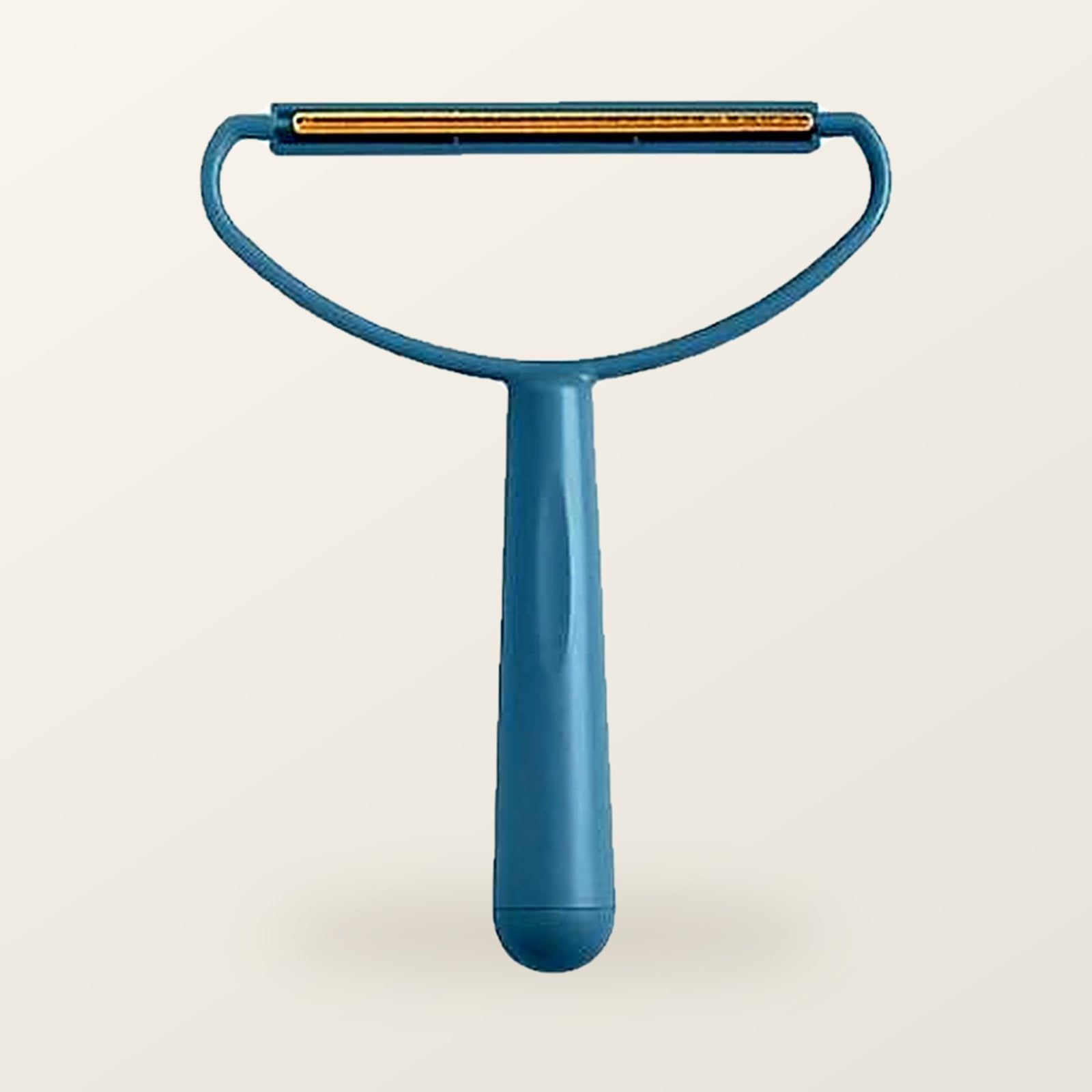 Teal fabric scraper with a brass blade, on a warm cream background