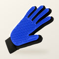 Blue silicone grooming glove with soft rubber nubs and a black mesh back, on a warm cream background